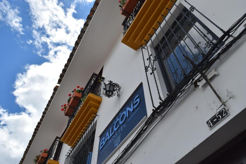 a building with a sign on the side of it at Les Balcons Hostel in Popayan