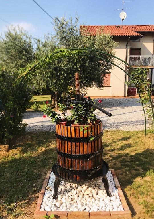 a barrel with a plant in a yard at Dimora Augusto & Valentina in Maiano