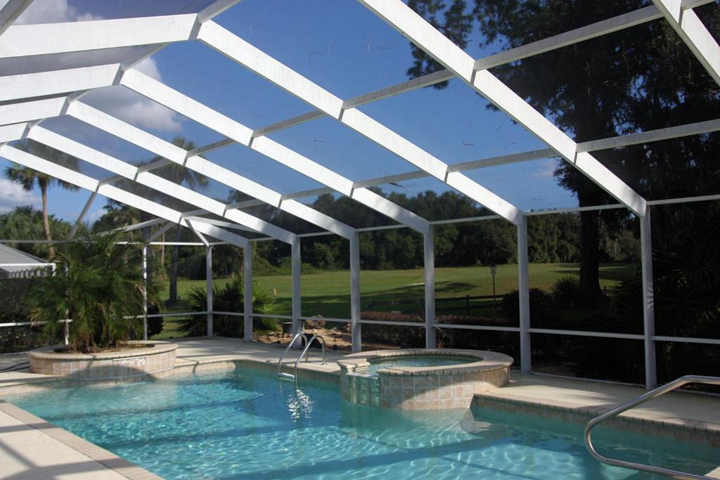 a white pergola over a swimming pool at Lakeside Vacations in Inverness