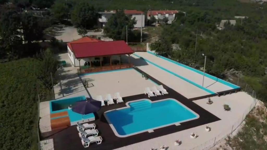 an aerial view of a swimming pool with a resort at Holiday Home Poljičko Imanje in Donji Dolac