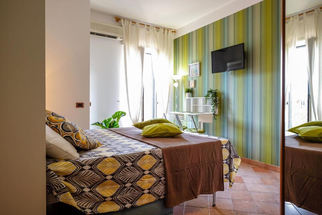 a hotel room with a bed and a television at The Best Rent - City View Apartment in Milan