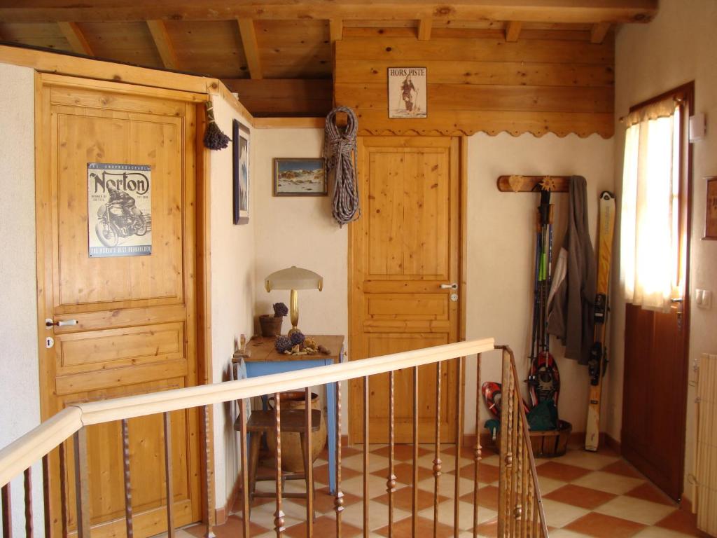 a hallway with a wooden door and a staircase at Stella Alpina in Rimplas