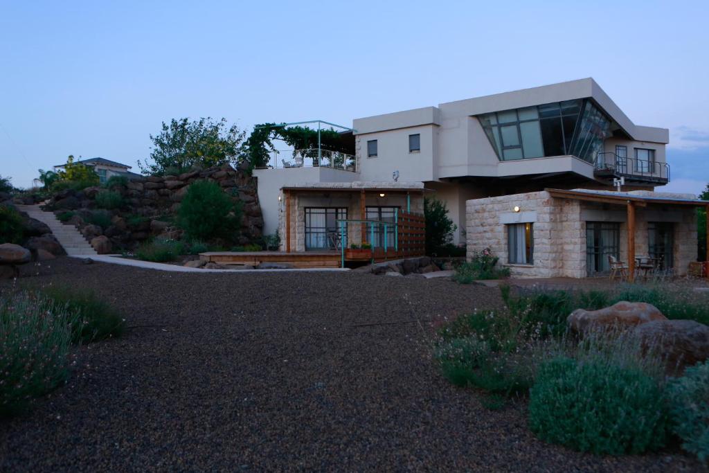 a house on a hill with a gravel driveway at B&B - Racheli Bar-Lev in Had Nes