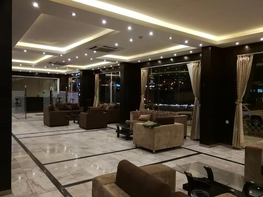 a lobby with couches and chairs in a building at Saad Palace Residential Units - Al Rabwa 2 in Abha