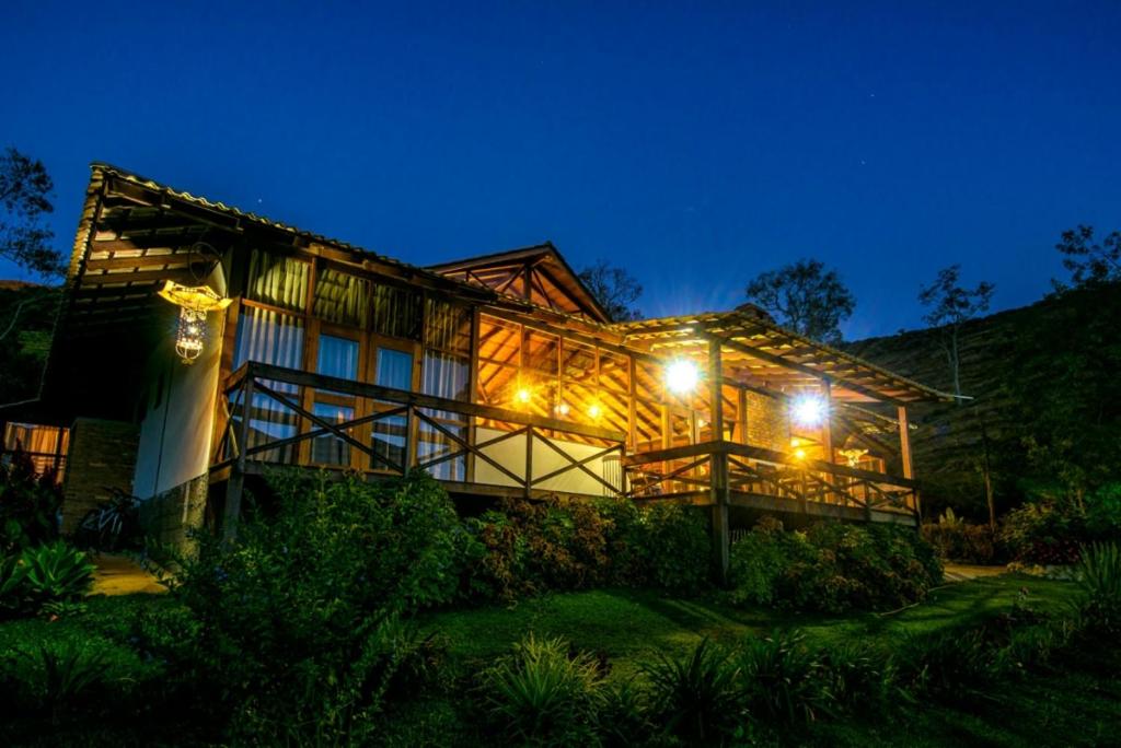 a large house with lights on the side of it at Casa do Lago Caparaó in Pedra Menina