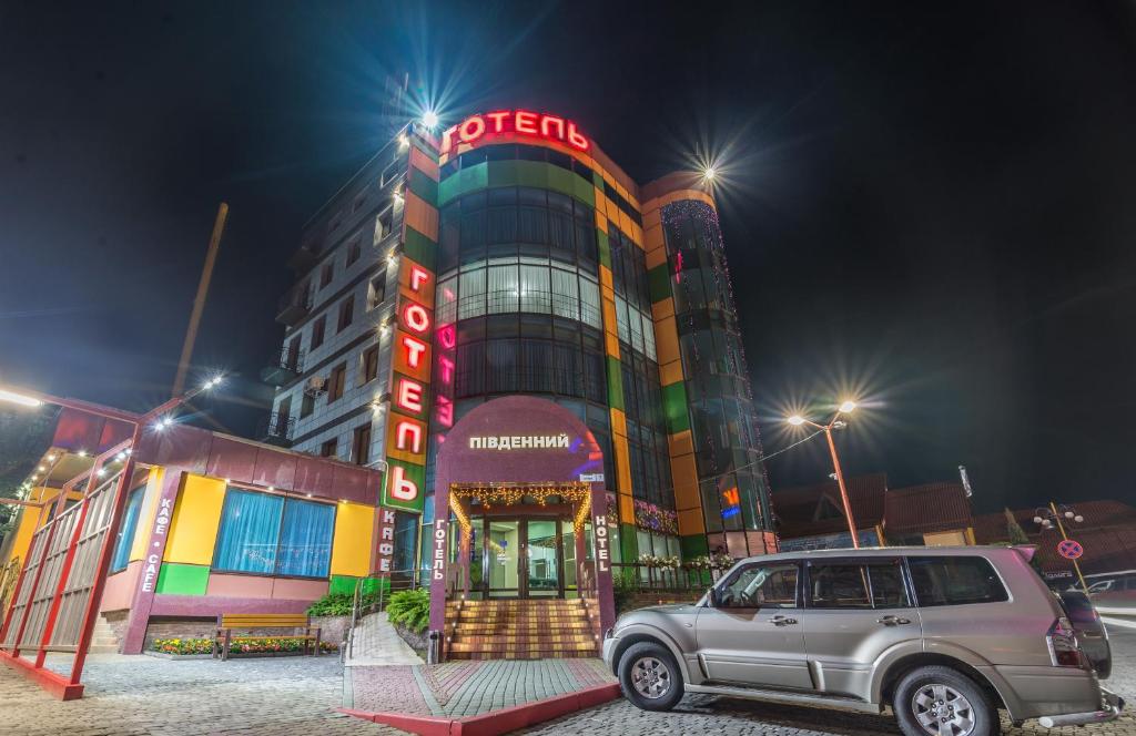 a car parked in front of a building at night at Pivdenniy in Lviv