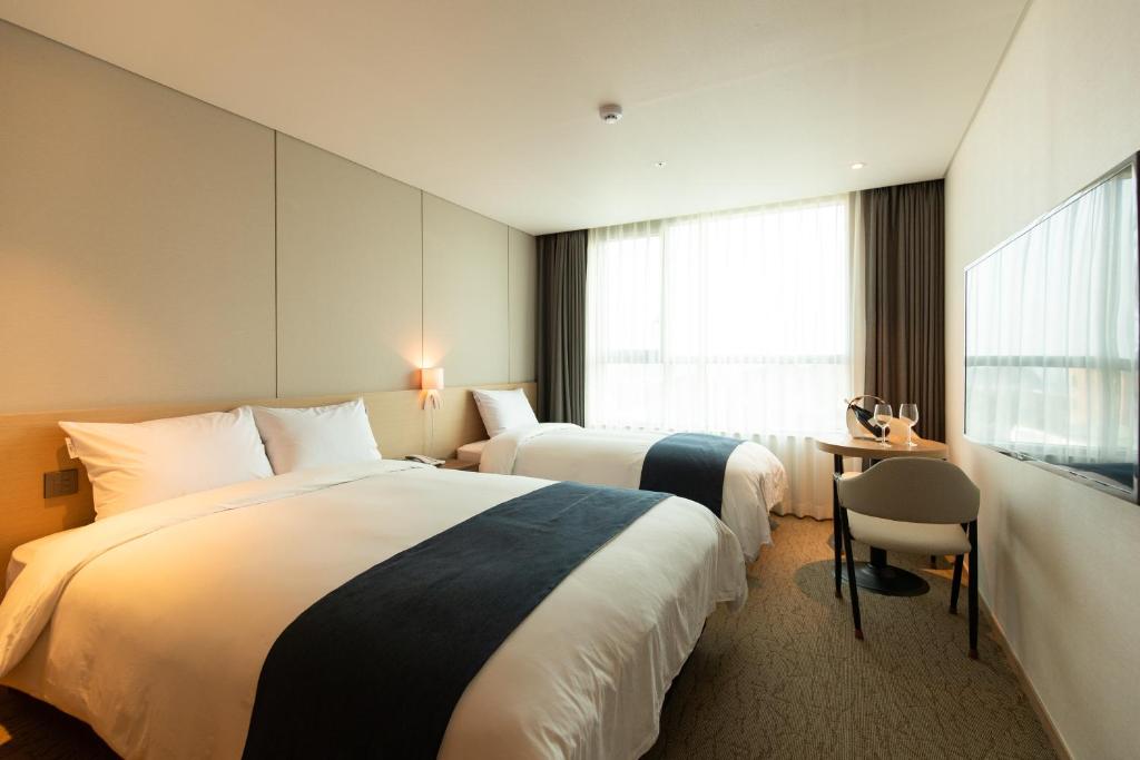 Postel nebo postele na pokoji v ubytování Hotel Winstory