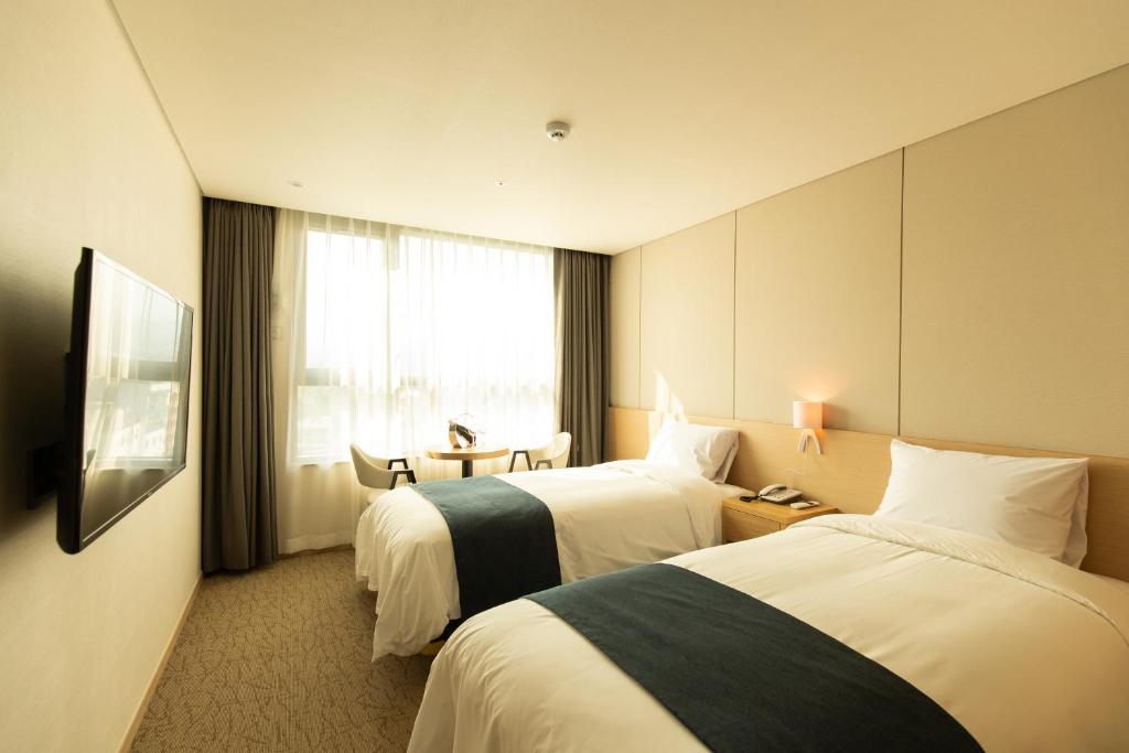 Postel nebo postele na pokoji v ubytování Hotel Winstory