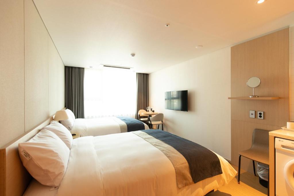 Postel nebo postele na pokoji v ubytování Hotel Winstory