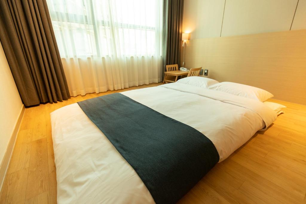 Postel nebo postele na pokoji v ubytování Hotel Winstory