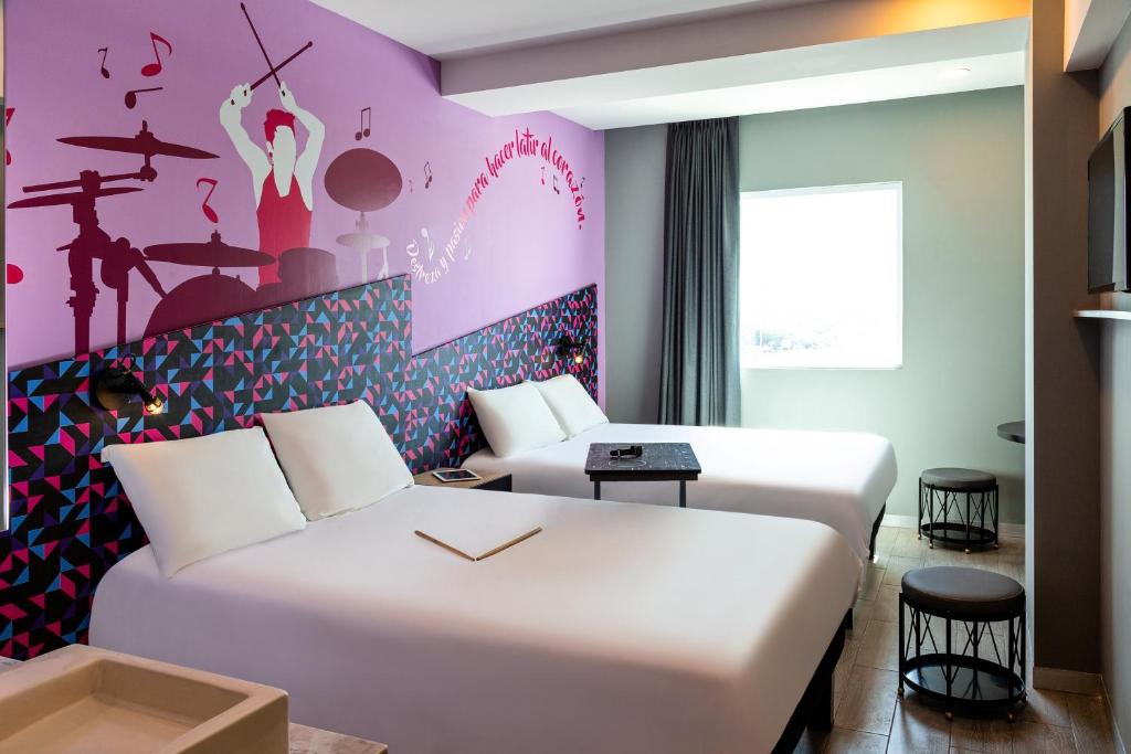 Postel nebo postele na pokoji v ubytování Ibis Styles Merida Galerias