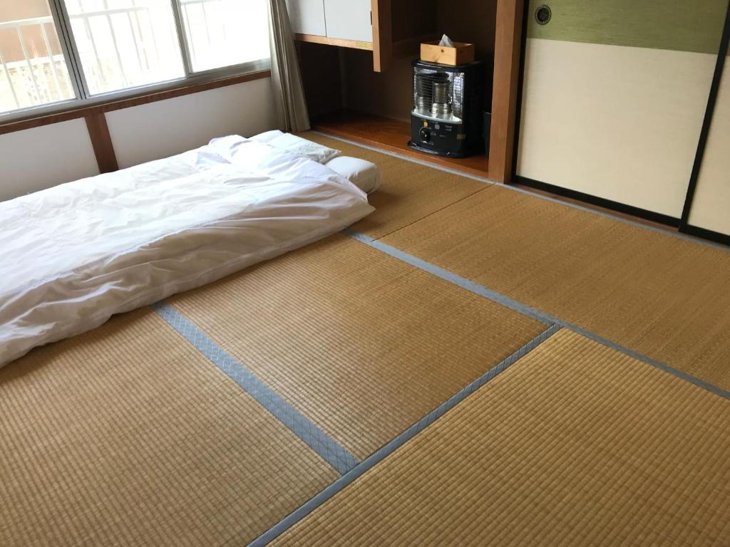 Postel nebo postele na pokoji v ubytování Guest House Itokawa
