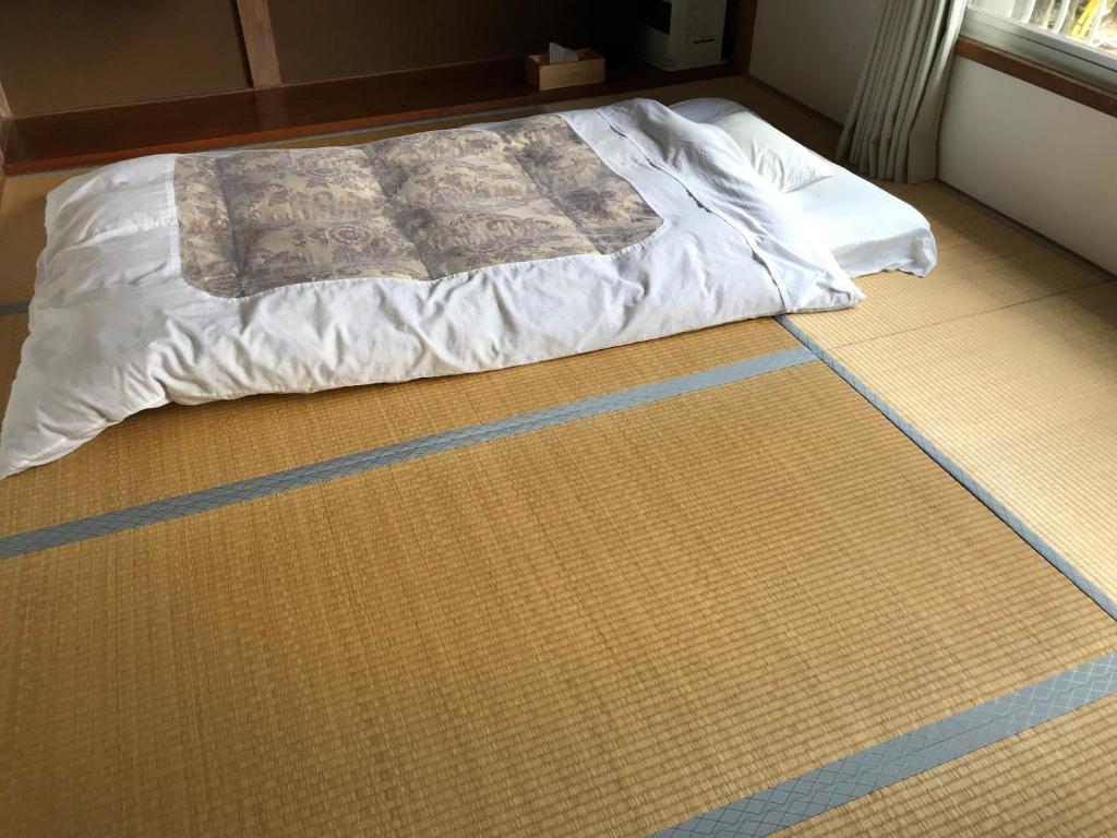 Postel nebo postele na pokoji v ubytování Guest House Itokawa