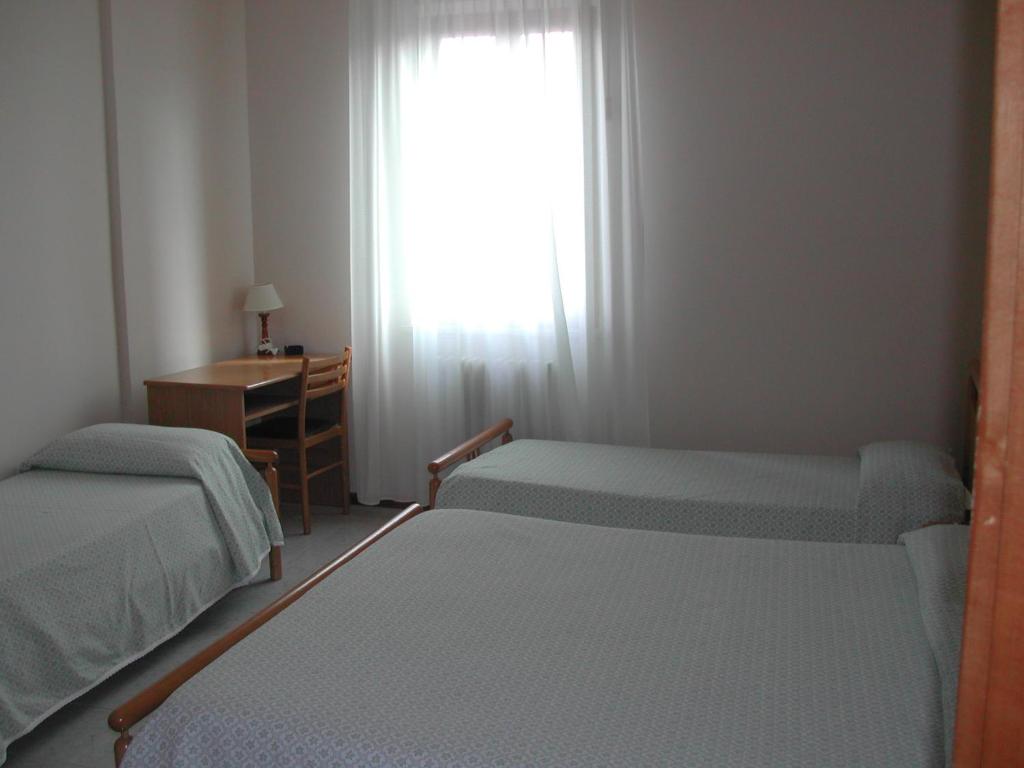 Postel nebo postele na pokoji v ubytování Hotel Centrale di Paolo e Cinzia