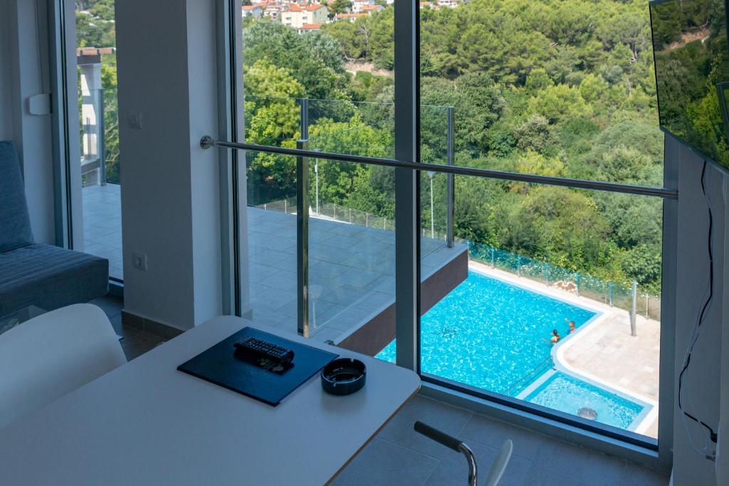 a room with a view of a swimming pool through a window at Premantura Resort - Hotel & Restaurant in Premantura