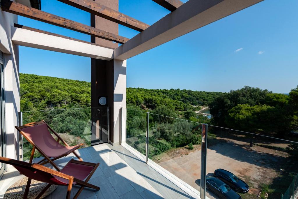 a view from the balcony of a house with chairs at Premantura Resort - Hotel & Restaurant in Premantura
