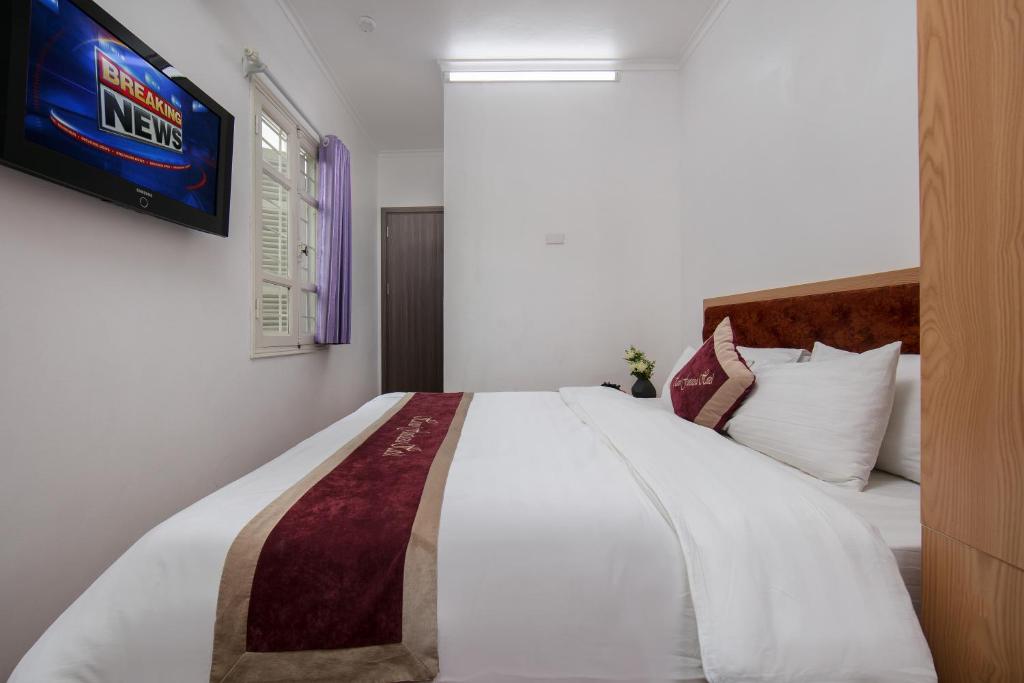 Postel nebo postele na pokoji v ubytování Hanoi Fantasea Hotel