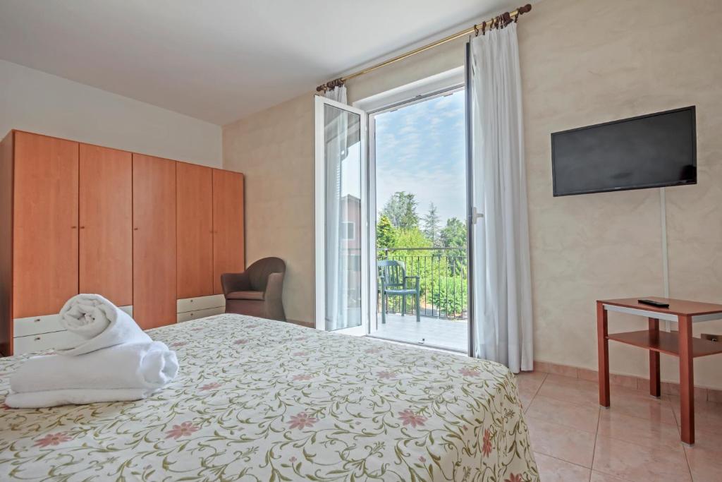Postel nebo postele na pokoji v ubytování Albergo Rondò