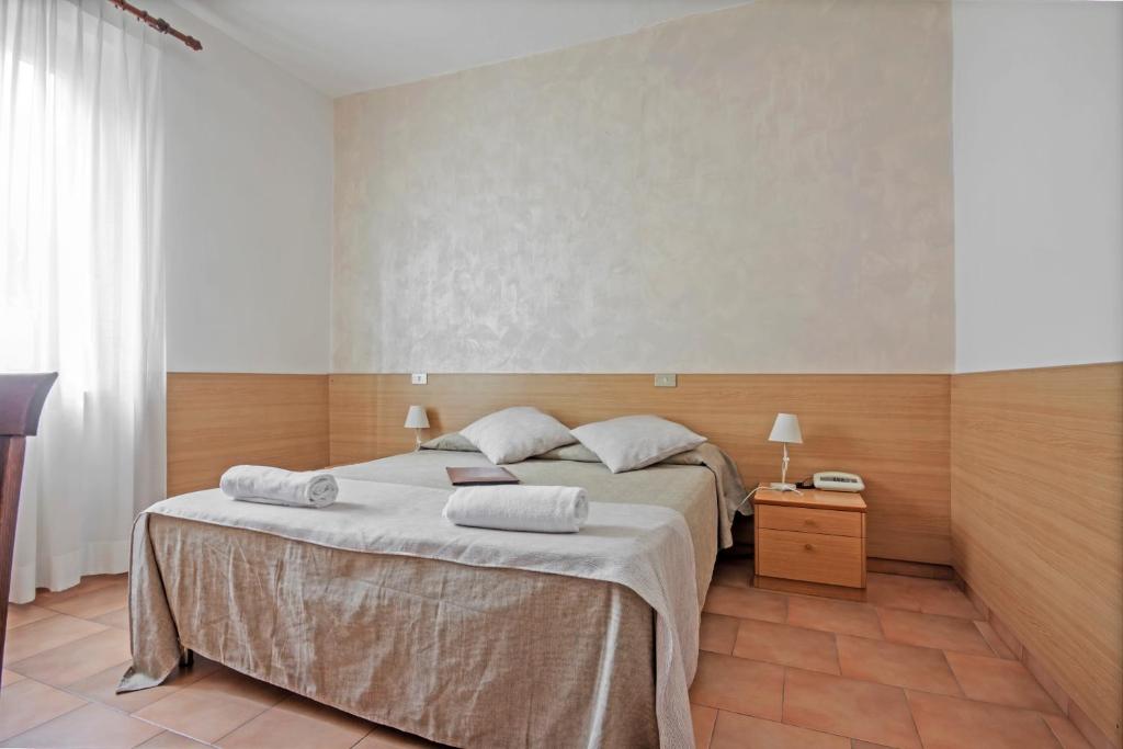 Postel nebo postele na pokoji v ubytování Albergo Rondò
