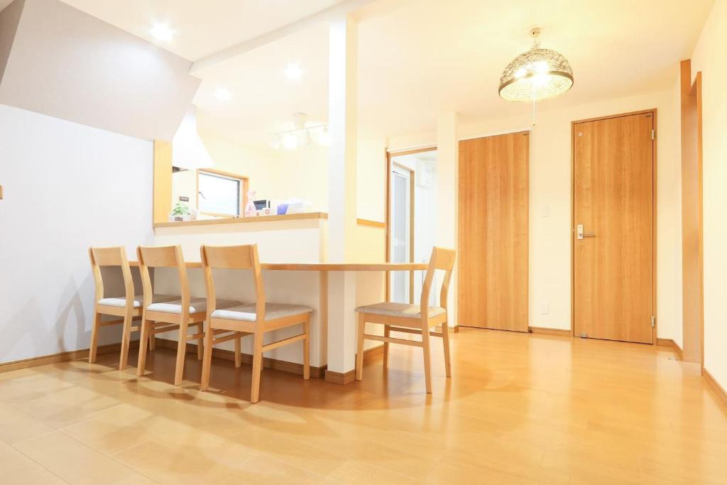 a dining room with a table and chairs at Tokaichi inn 一軒家貸切 in Hiroshima