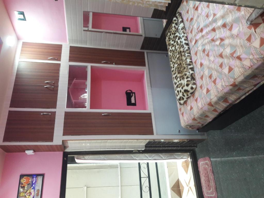 a view of a room with a door and a room with pink at Rks Homestay in Hampi