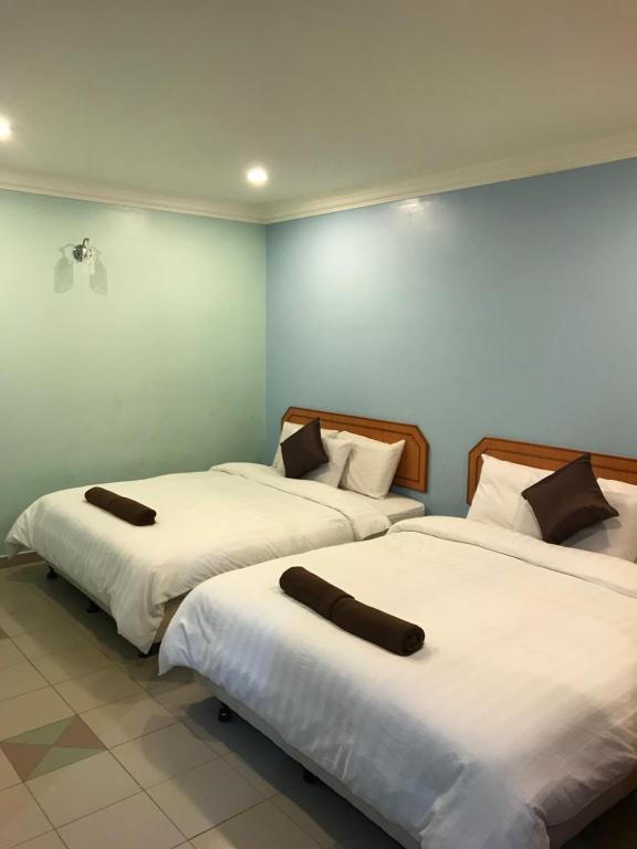 Postel nebo postele na pokoji v ubytování Hotel dan Restoran Seri Kangsar