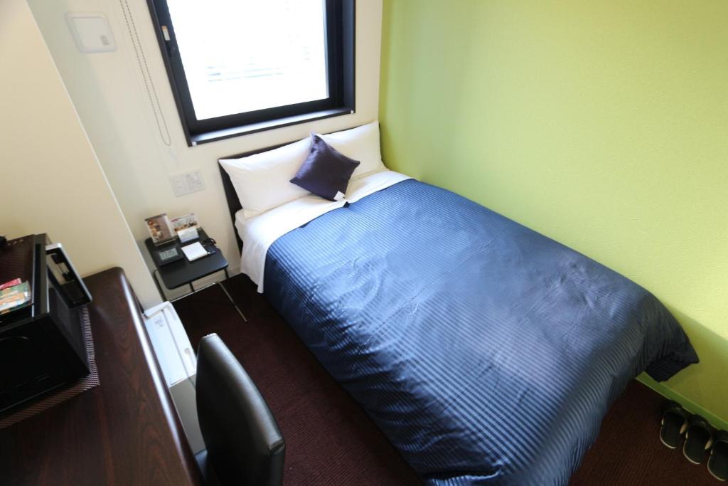 Postel nebo postele na pokoji v ubytování HOTEL LiVEMAX Ueno-Ekimae