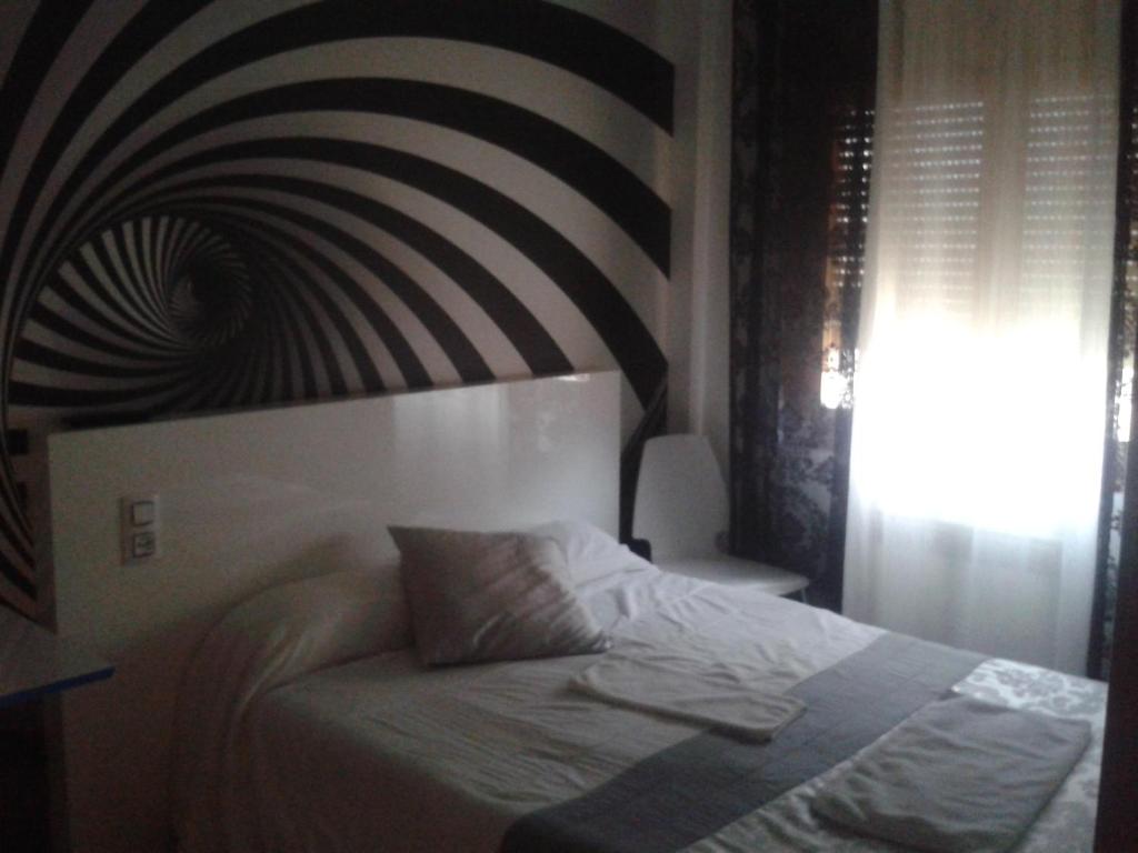 Postel nebo postele na pokoji v ubytování Hostal Texas 2