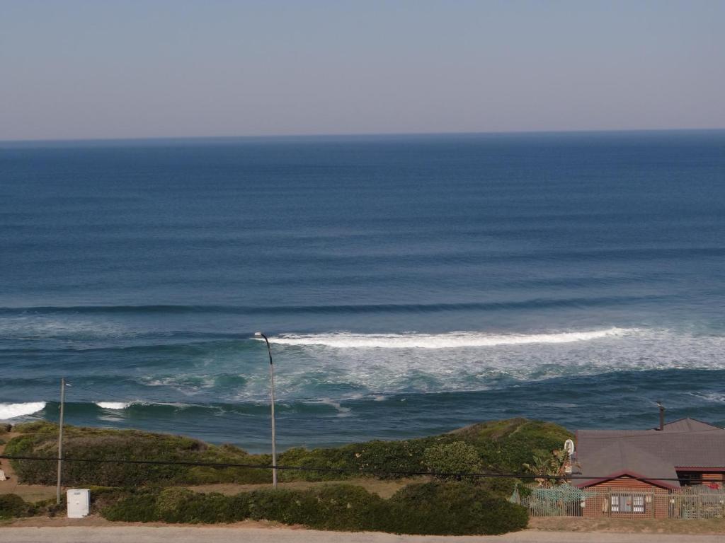 a view of the ocean with a street light at Beach House On 18p Repens in Mossel Bay