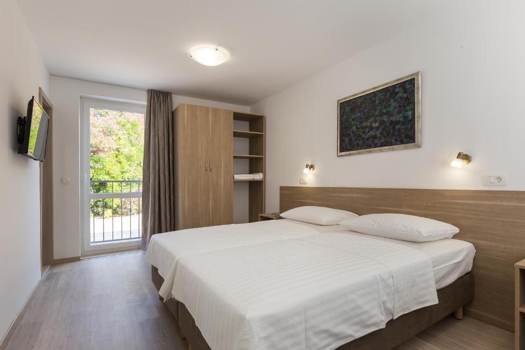 Posteľ alebo postele v izbe v ubytovaní Hotel Vimbula - Komolac