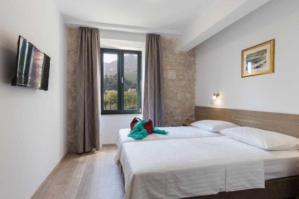 Posteľ alebo postele v izbe v ubytovaní Hotel Vimbula - Komolac