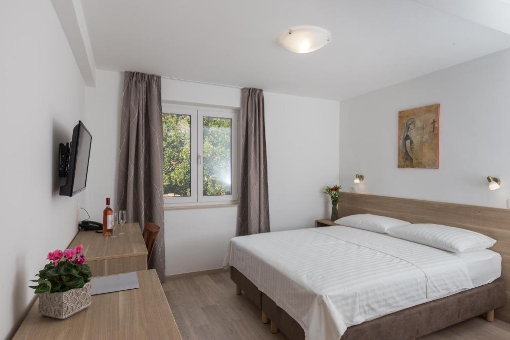 Posteľ alebo postele v izbe v ubytovaní Hotel Vimbula - Komolac