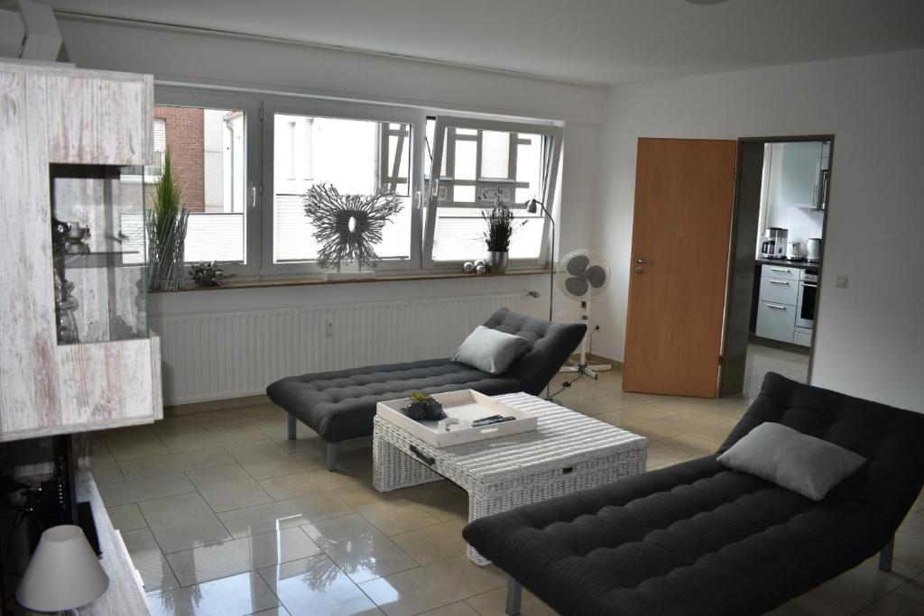 a living room with two couches and a coffee table at My Home - Ferienwohnung in Lüdinghausen
