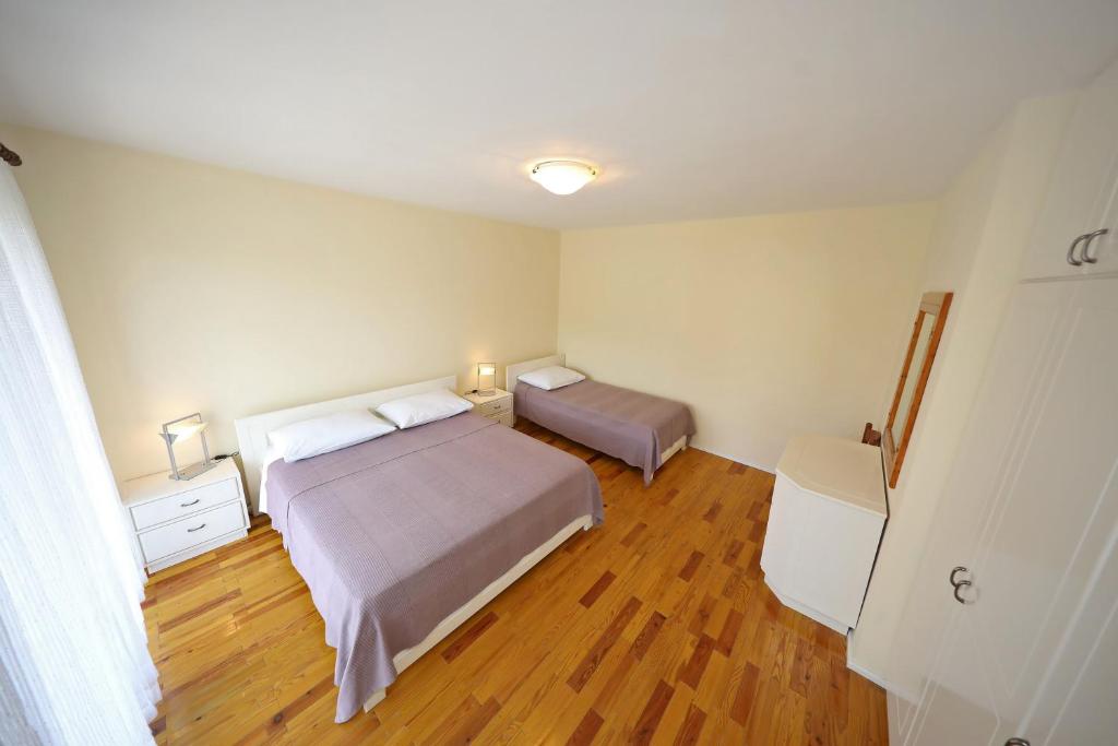 Posteľ alebo postele v izbe v ubytovaní Girica Apartments