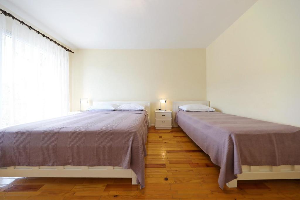 Posteľ alebo postele v izbe v ubytovaní Girica Apartments