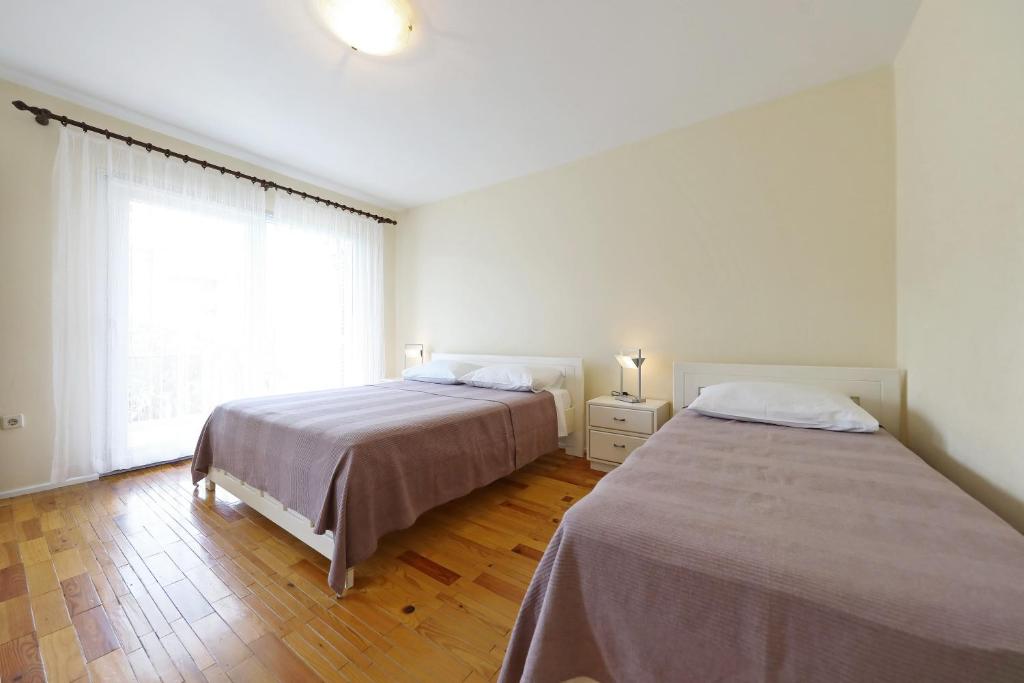 Posteľ alebo postele v izbe v ubytovaní Girica Apartments