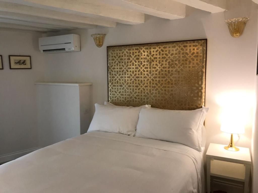 Posteľ alebo postele v izbe v ubytovaní Suites alla Maddalena