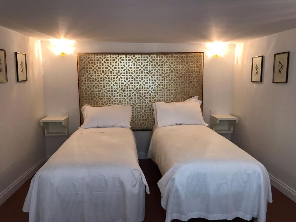 Posteľ alebo postele v izbe v ubytovaní Suites alla Maddalena