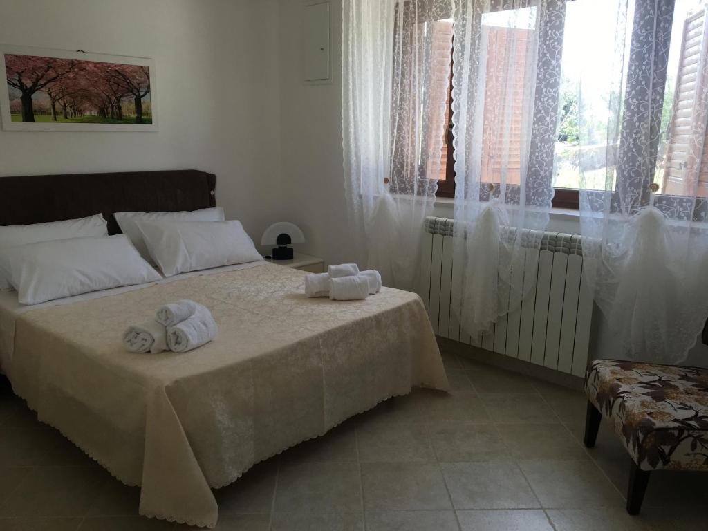a bedroom with a bed with towels on it at La casa di Colino e Annina in Monopoli