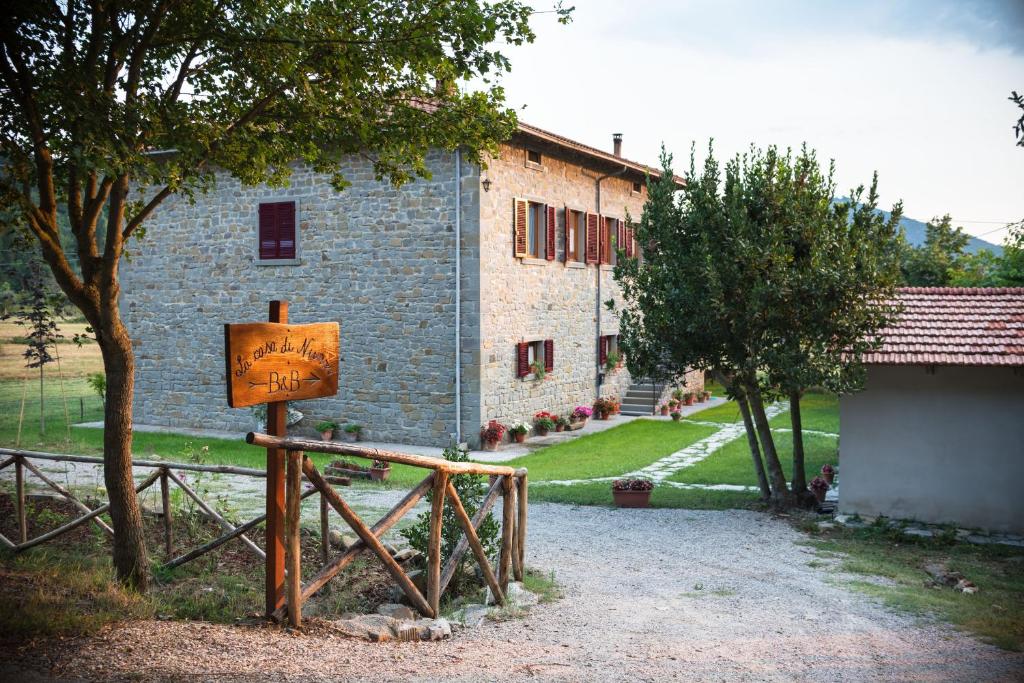 a large stone building with a sign in front of it at La casa di Nunzi in Cortona