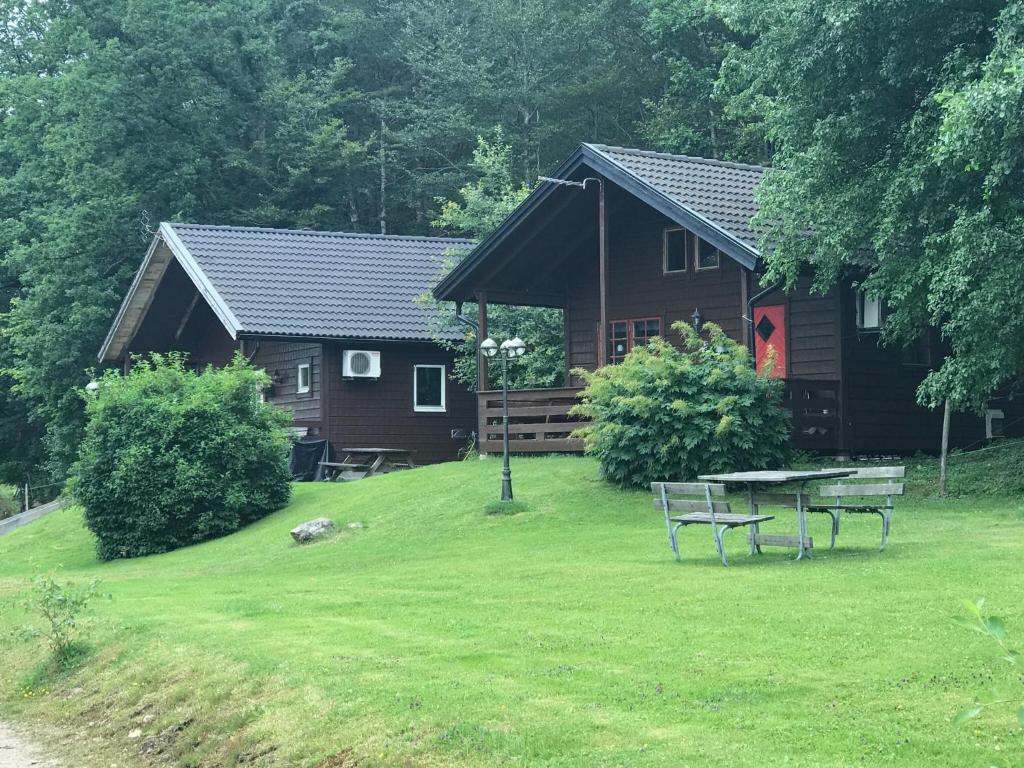 a log cabin with a picnic table in the yard at Örnatorpet Ullared in Ullared