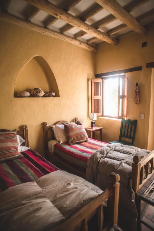 Una cama o camas en una habitación de Casa del Tejedor
