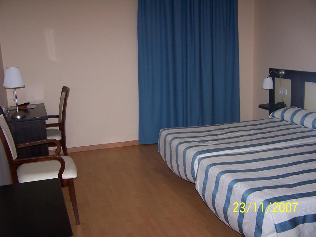 Postel nebo postele na pokoji v ubytování Hotel Castillo