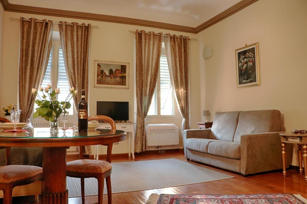a living room with a table and a couch at Luxury Fiesolana apartment in Florence