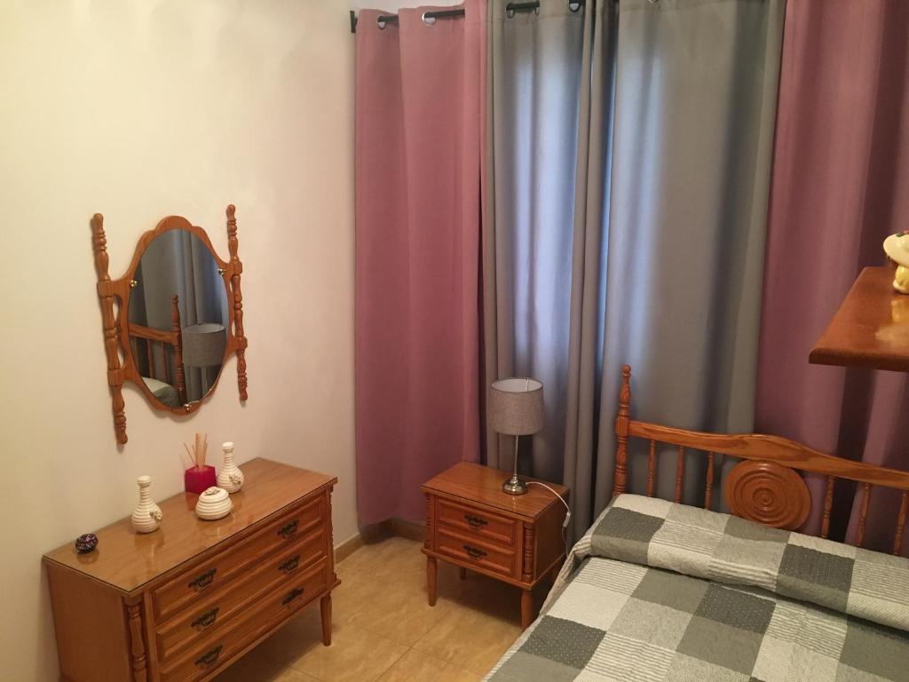 a bedroom with a bed and a tv on a dresser at Casa Carmelito in Moya