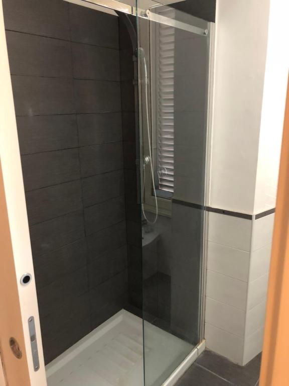 a shower with a glass door in a bathroom at Elle Cavour Guest House in Rome