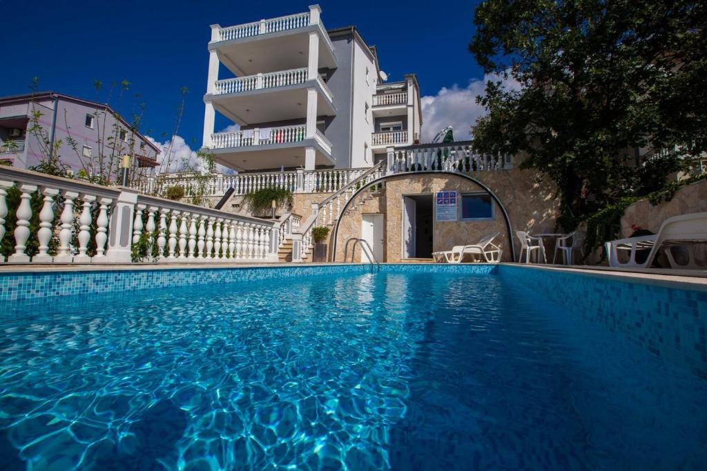 a swimming pool in front of a building at Apartment Crikvenica, Vinodol 5 in Crikvenica