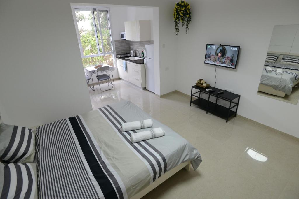 a bedroom with a bed with towels on it at Olga Beach Apartment 28 in Haifa