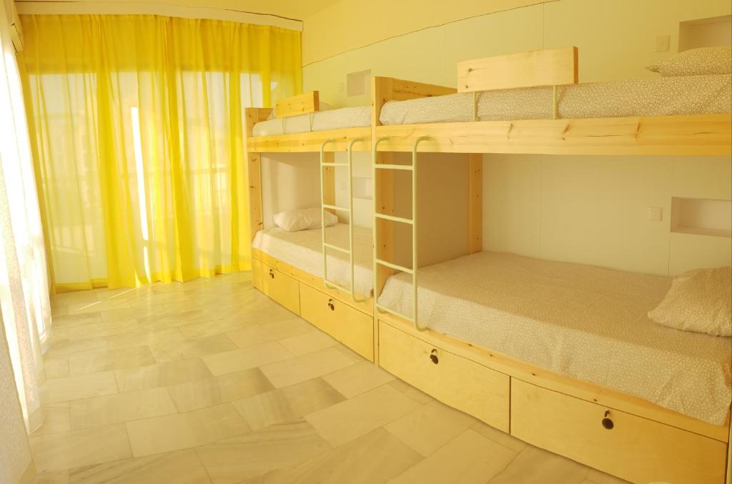 a room with two bunk beds and a wooden floor at NEX Hostel in Nicosia