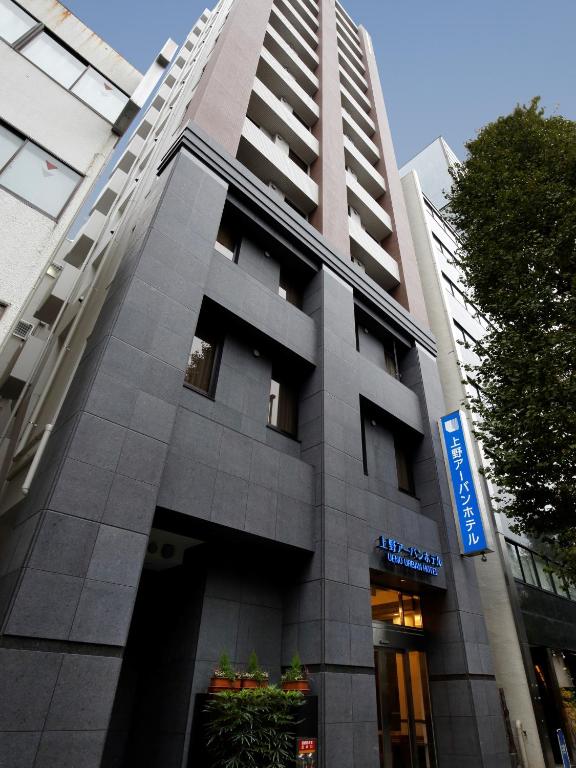 a building with a sign on the side of it at Ueno Urban Hotel in Tokyo